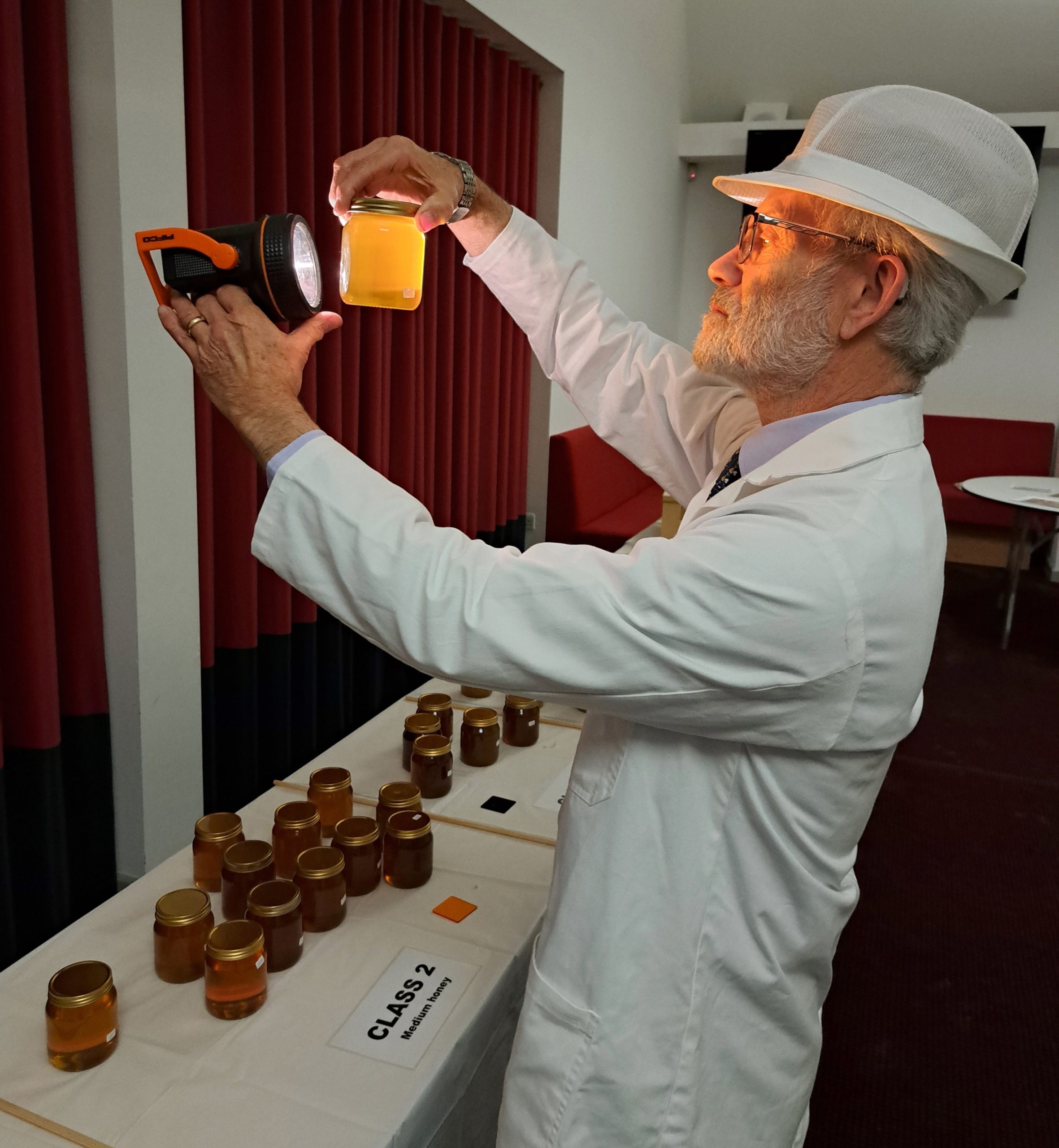 Ivor Flatman judging the honey classes